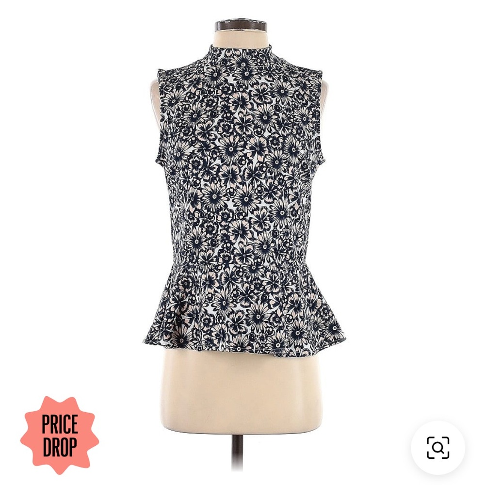 Sleeveless peplum top with floral print in navy blue and white